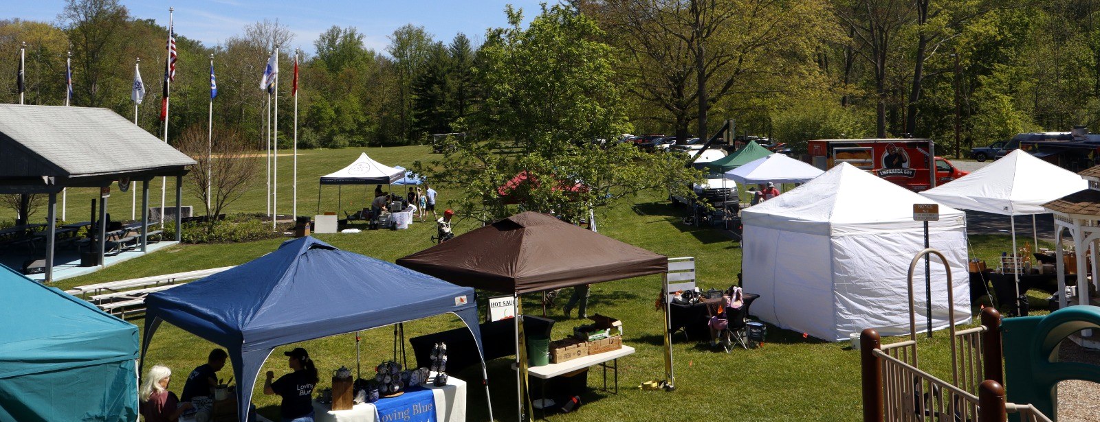 Tents, food trucks and visitors filling the field at Trout Fest