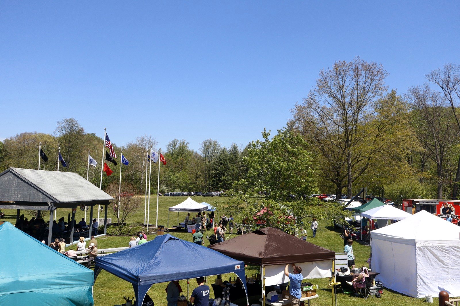 Trout Fest at Califon Island Park - vendor tents, flags and the pavilion