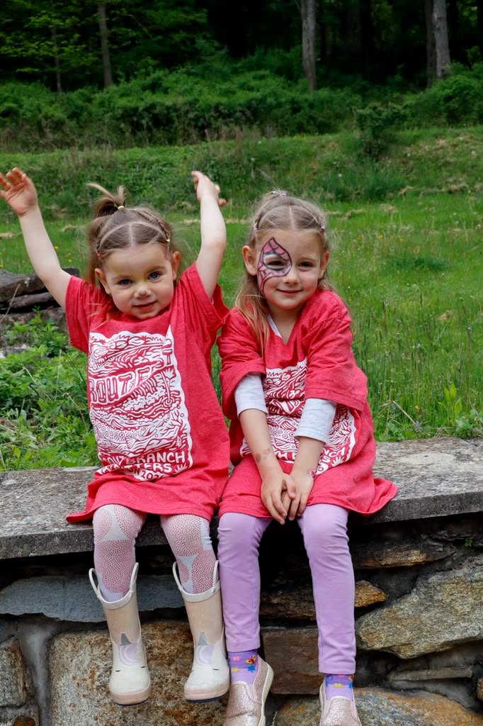 Two kids in Trout Fest t-shirts with face paint