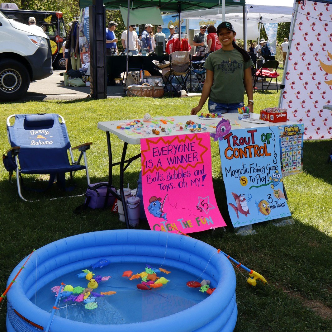 Kids' fishing game and Trout of Control activity table at Trout Fest